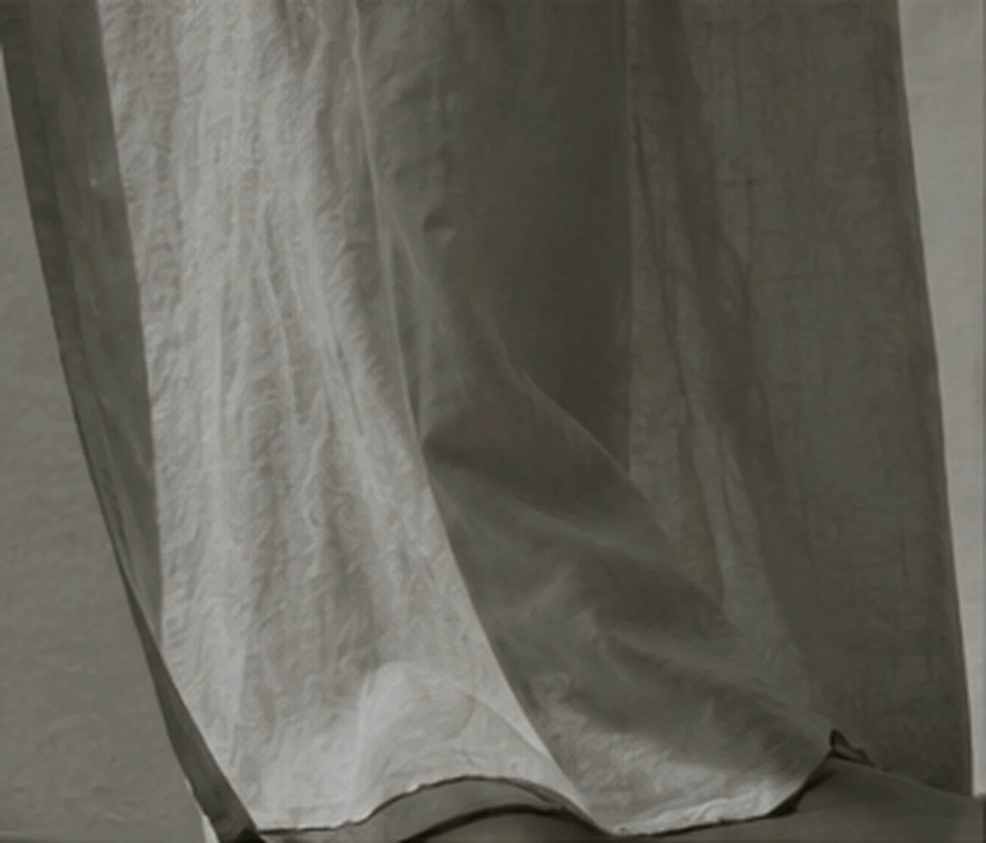 A linen curtain moving in soft daylight
